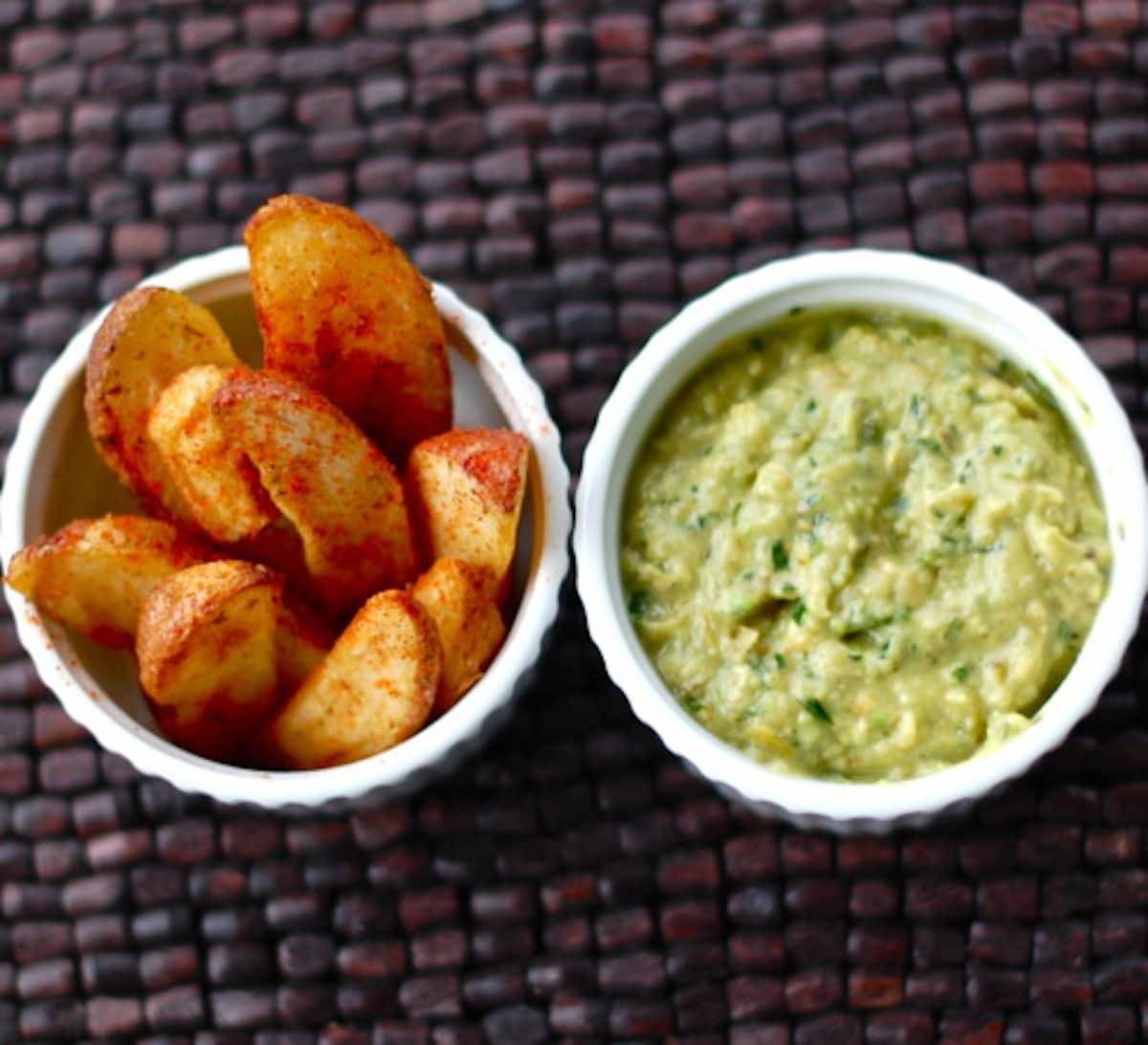 Avocado tomatillo dip with potato wedges.