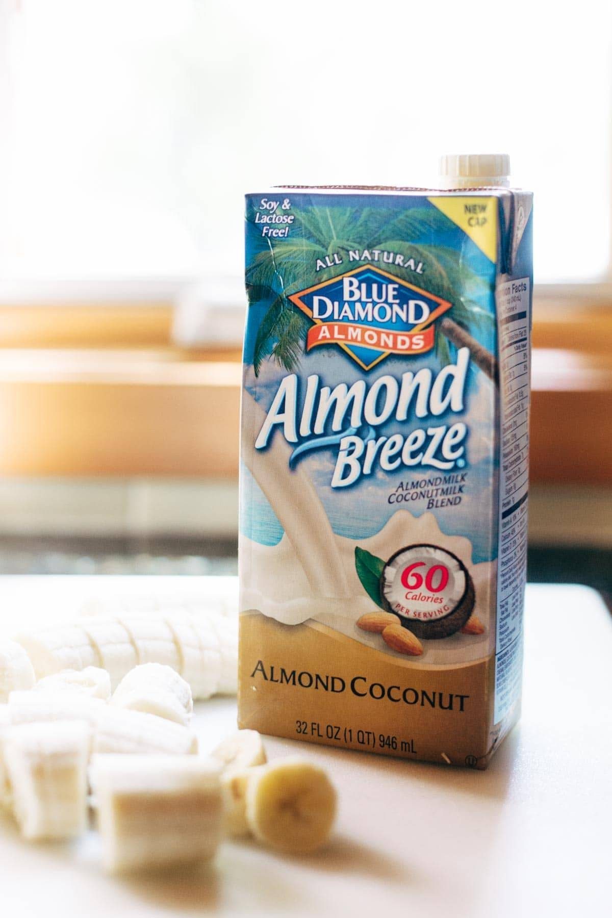 Bananas in front of almond breeze almond coconut milk.