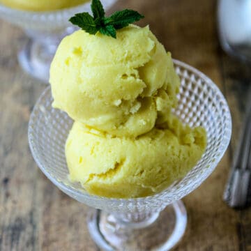 Mango coconut ice cream in a glass dish.