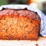 A loaf of banana bread wrapped in a blue and white cloth.