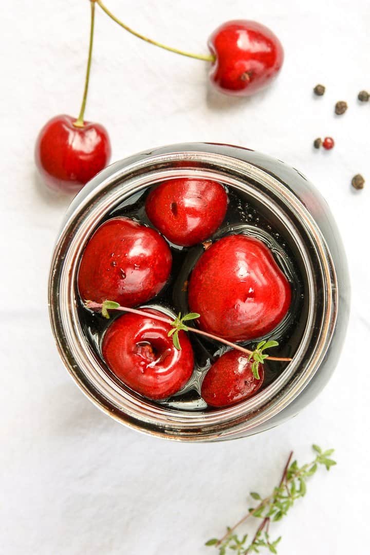 A jar of cherries on a table