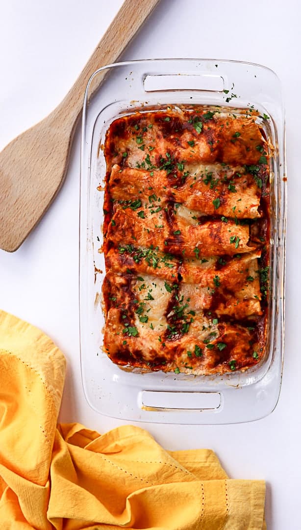 A pan of baked enchiladas on a table