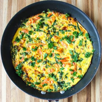 Salmon fritatta in a black skillet.