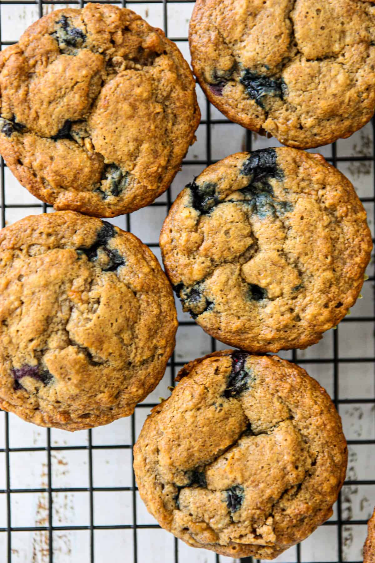 Banana blueberry oatmeal muffins cooling on a wire rack.