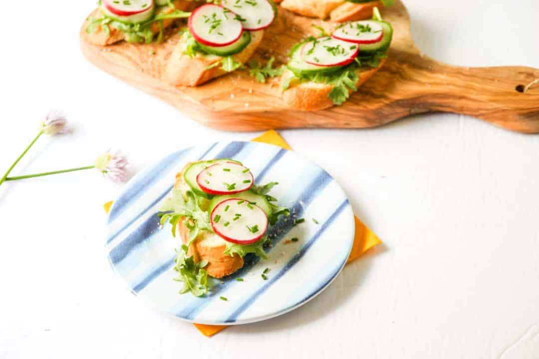 A plate of food on a table, with Radish and Cucumber