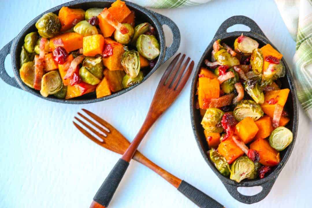 Two plates of Brussels sprouts and Butternut squash