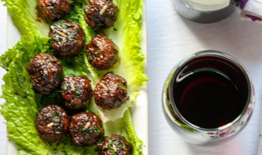 A plate of food and a glass of wine