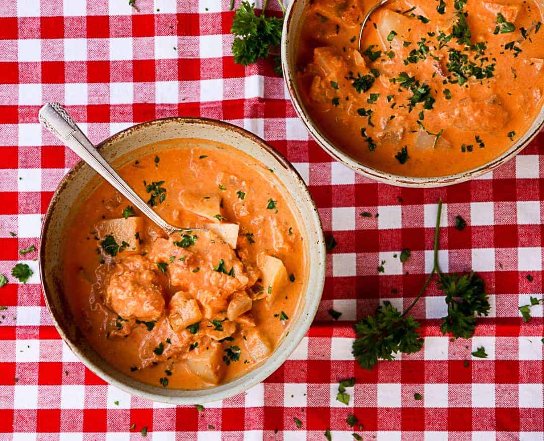 Two bowls of chowder on a table