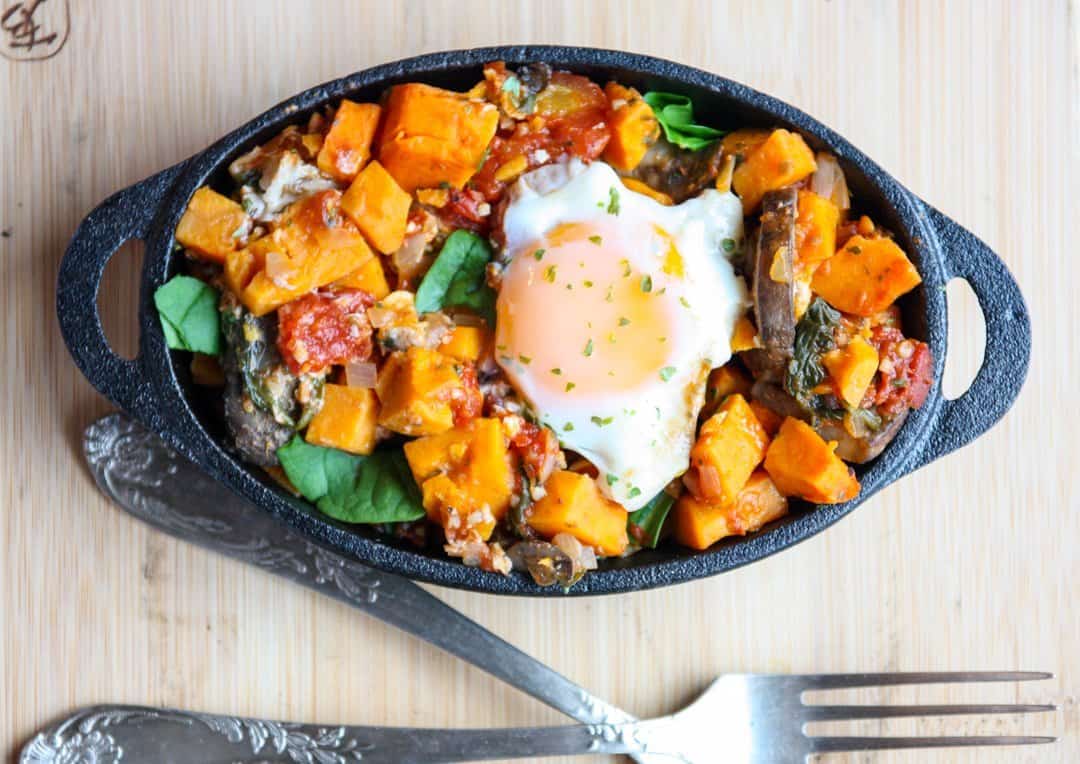 A bowl of food, topped with an egg