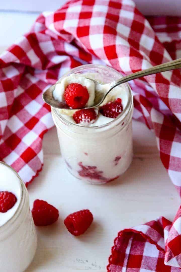 A jar of dessert with a spoon