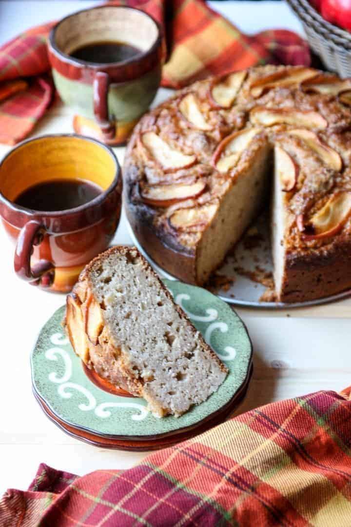 A close up of a slice of cake and a cup of coffee