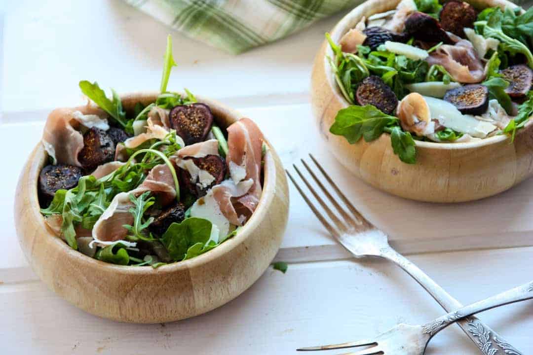 Two bowls of salad with Arugula and Prosciutto
