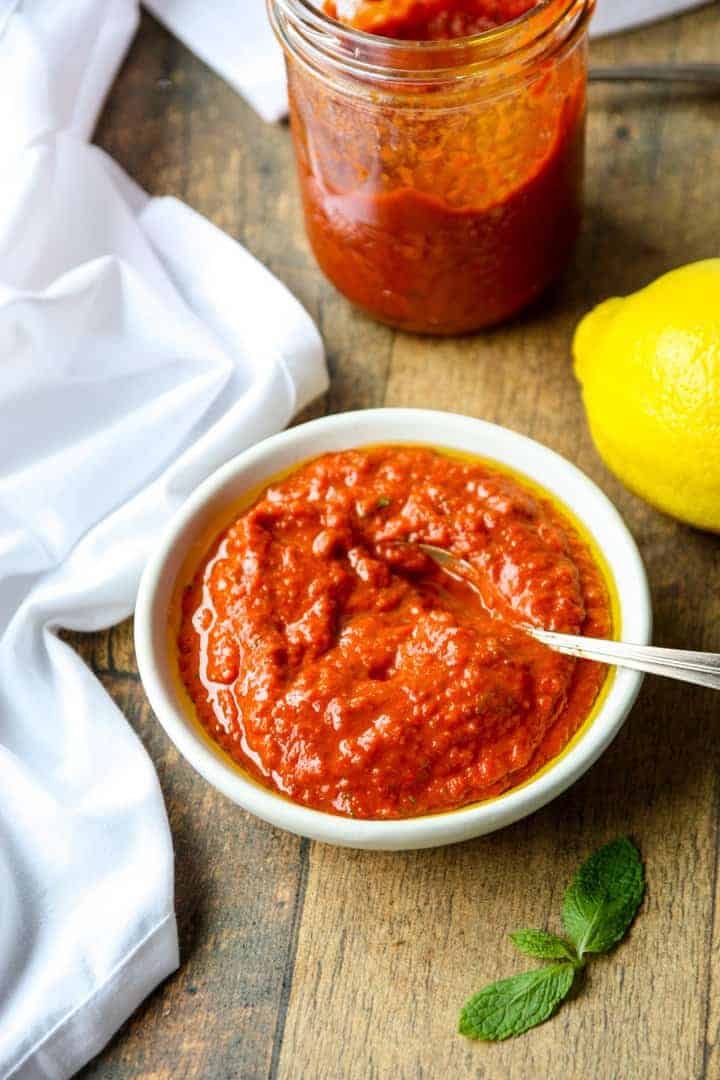 A bowl of sauce on a table