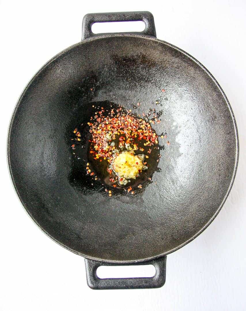 Oil, garlic and spices heating in a pan.