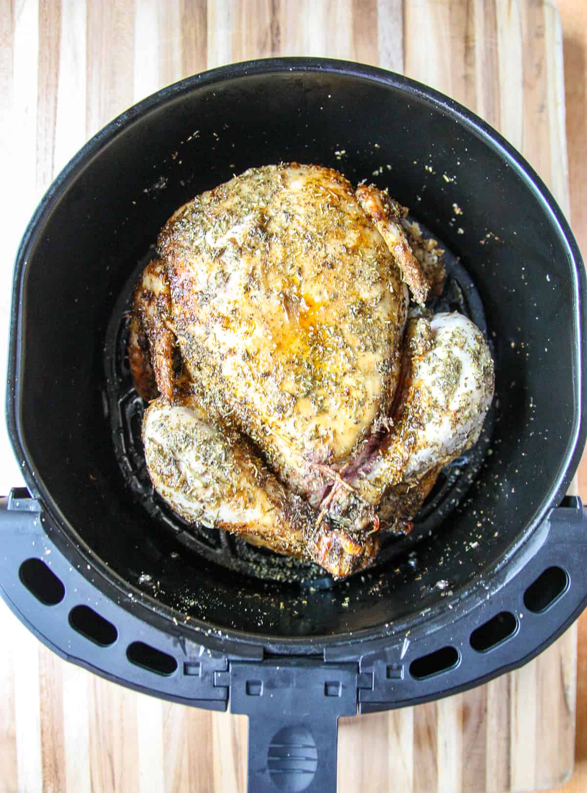 The chicken is flipped over halfway through cooking.