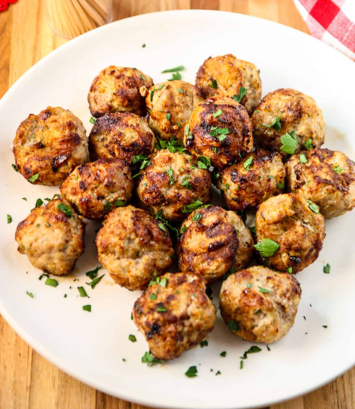 Air fried turkey meatballs on a white plate.