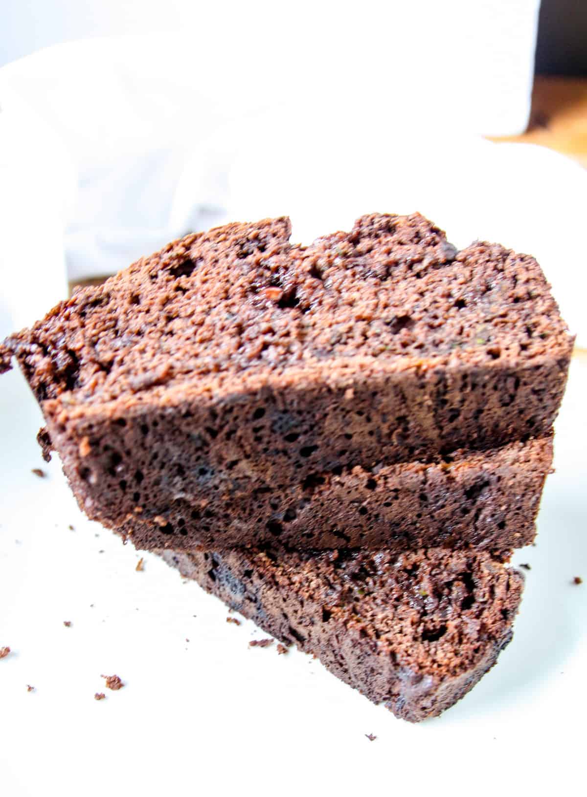 A stack of 3 slices of gluten-free zucchini bread.