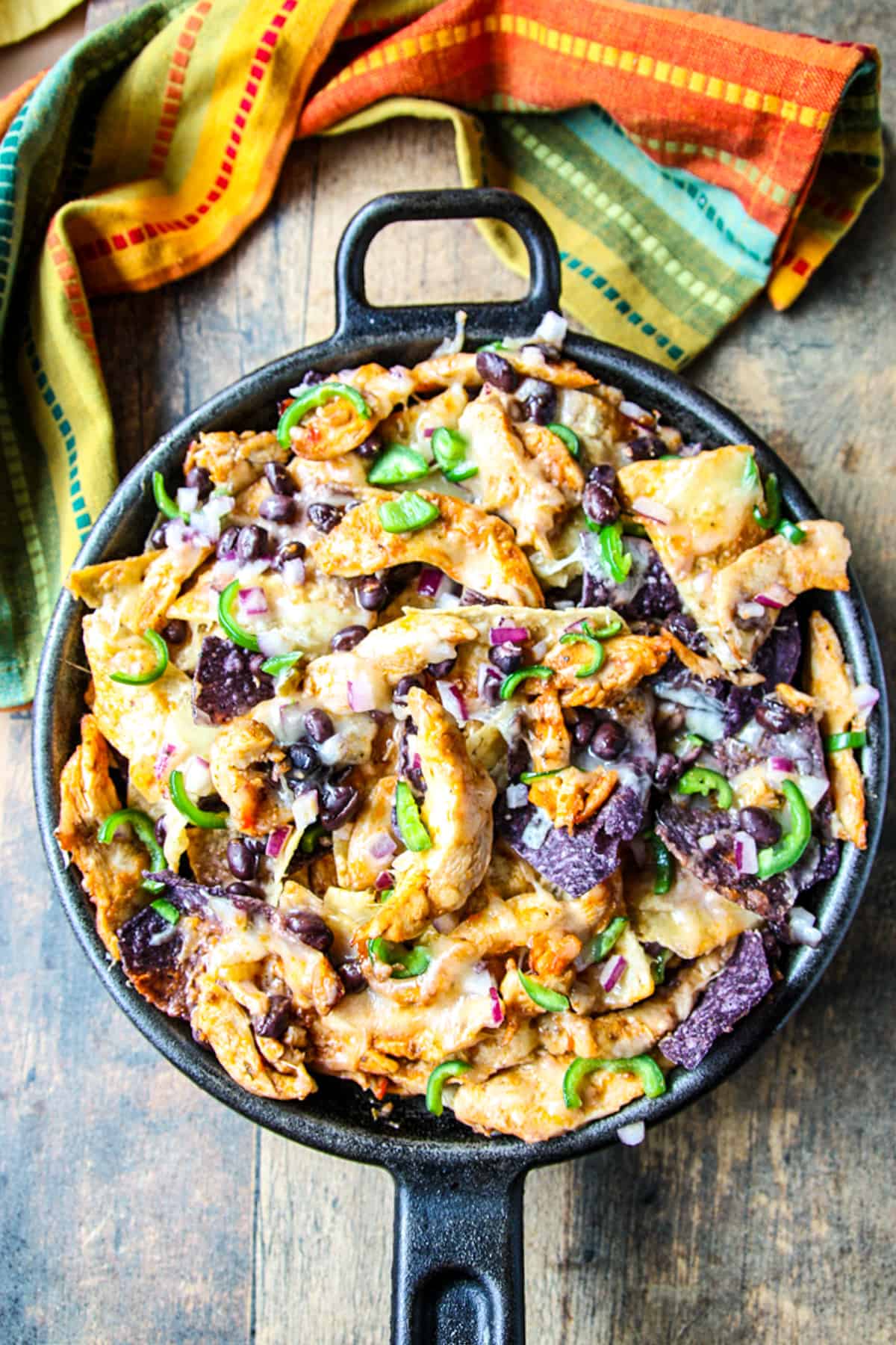 Leftover turkey nachos in a cast iron pan.