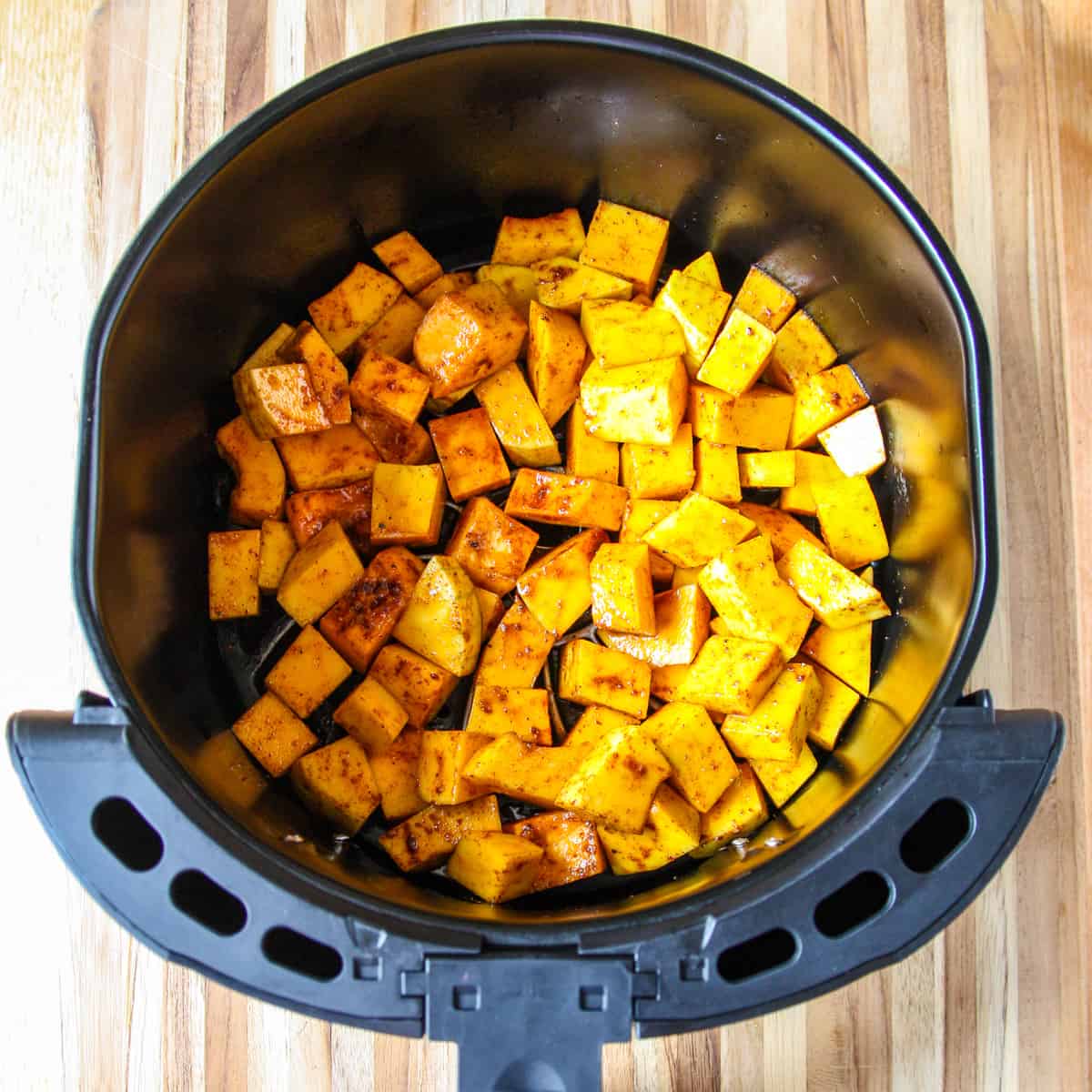 Squash in the air fryer basket ready to be cooked.