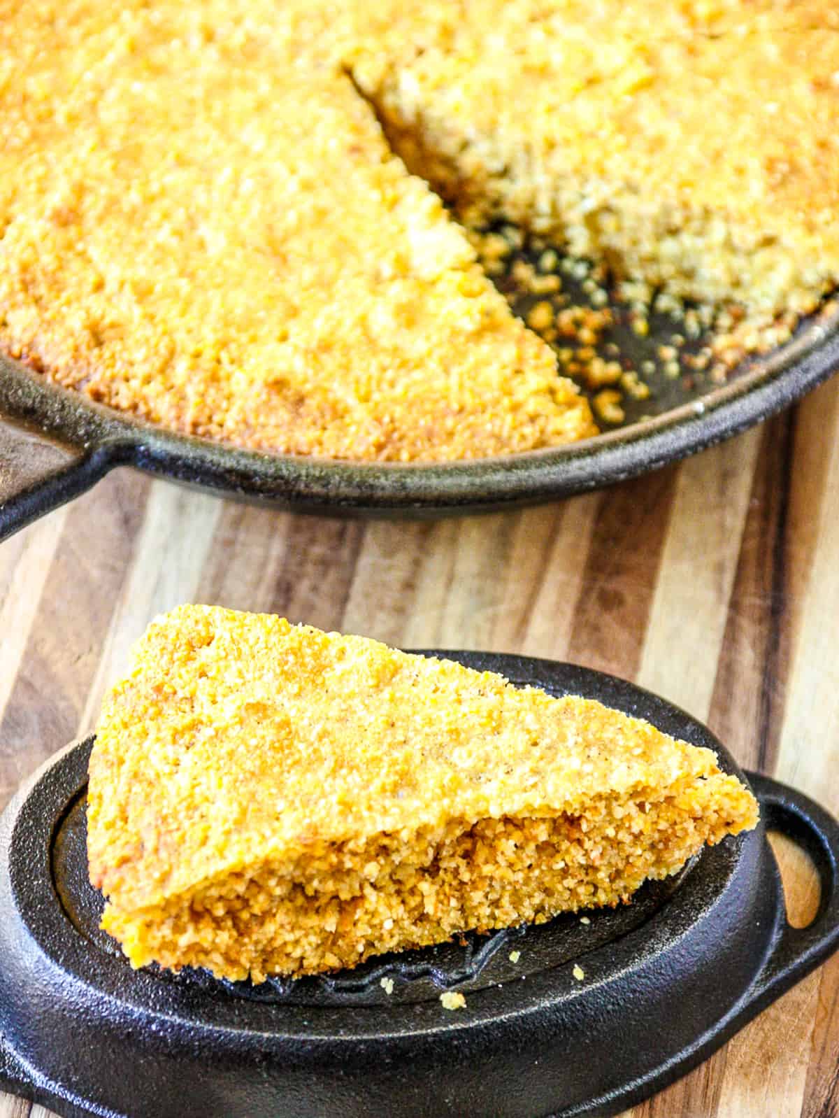 A pan of baked cornbread with a slice removed.