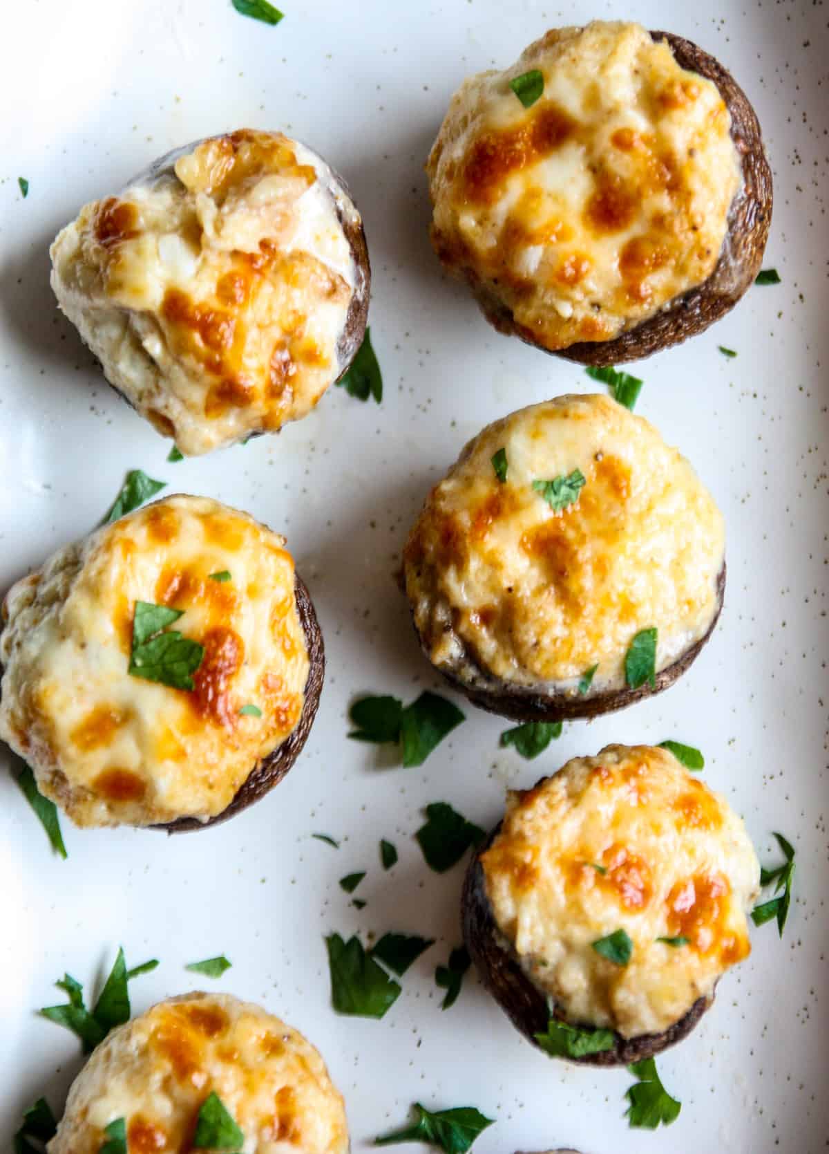 Air fryer stuffed mushrooms on a plate.
