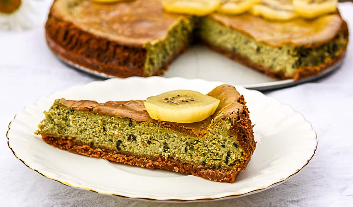 A slice of matcha cheesecake on a white plate.