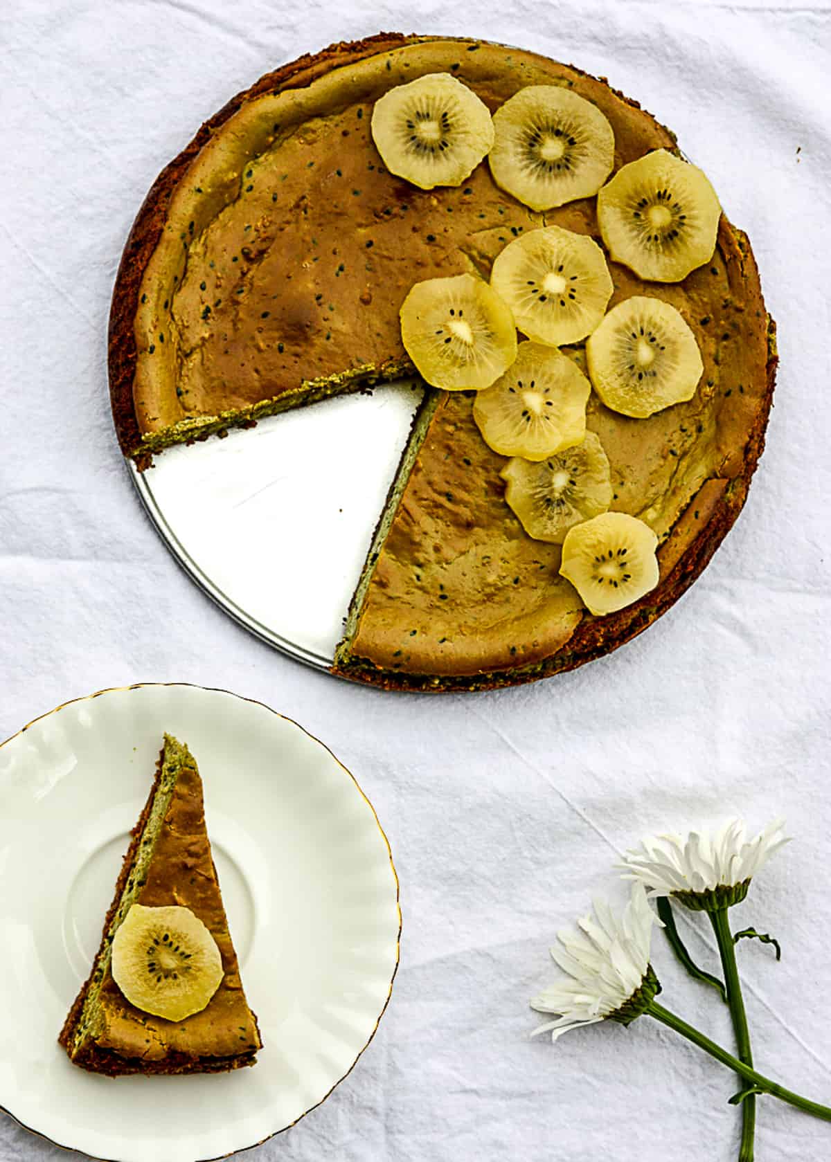 Cheesecake being sliced and placed on a white plate.