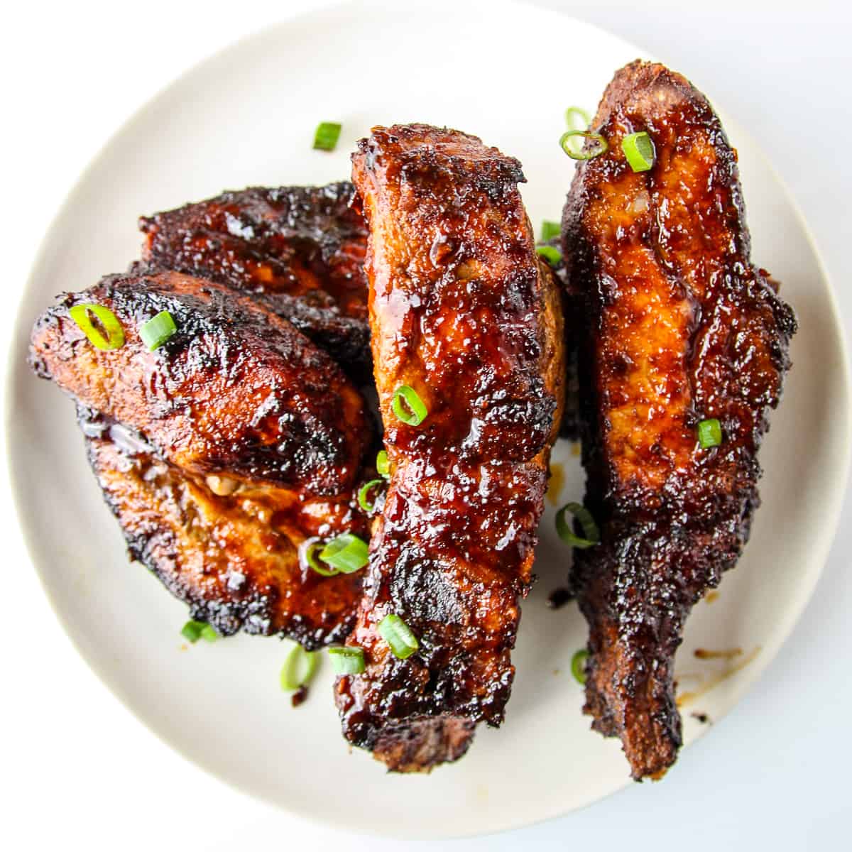 Air fryer country style ribs covered in barbecue sauce.