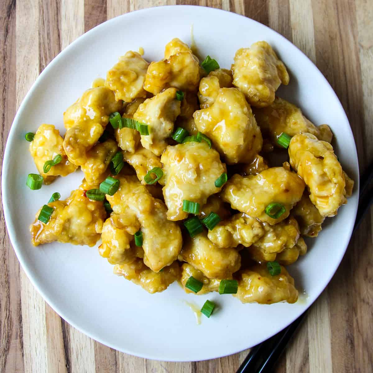Air fryer orange chicken on a white plate.