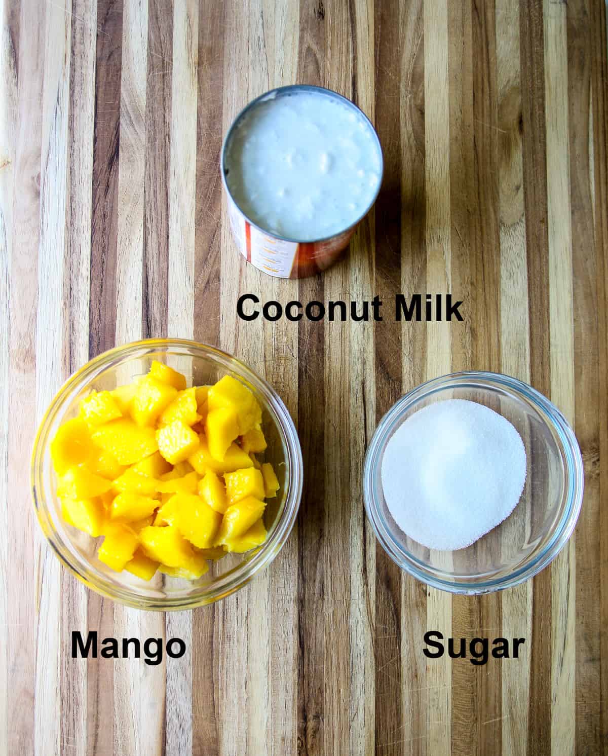 The ingredients to make the ice cream, on a wood cutting board.