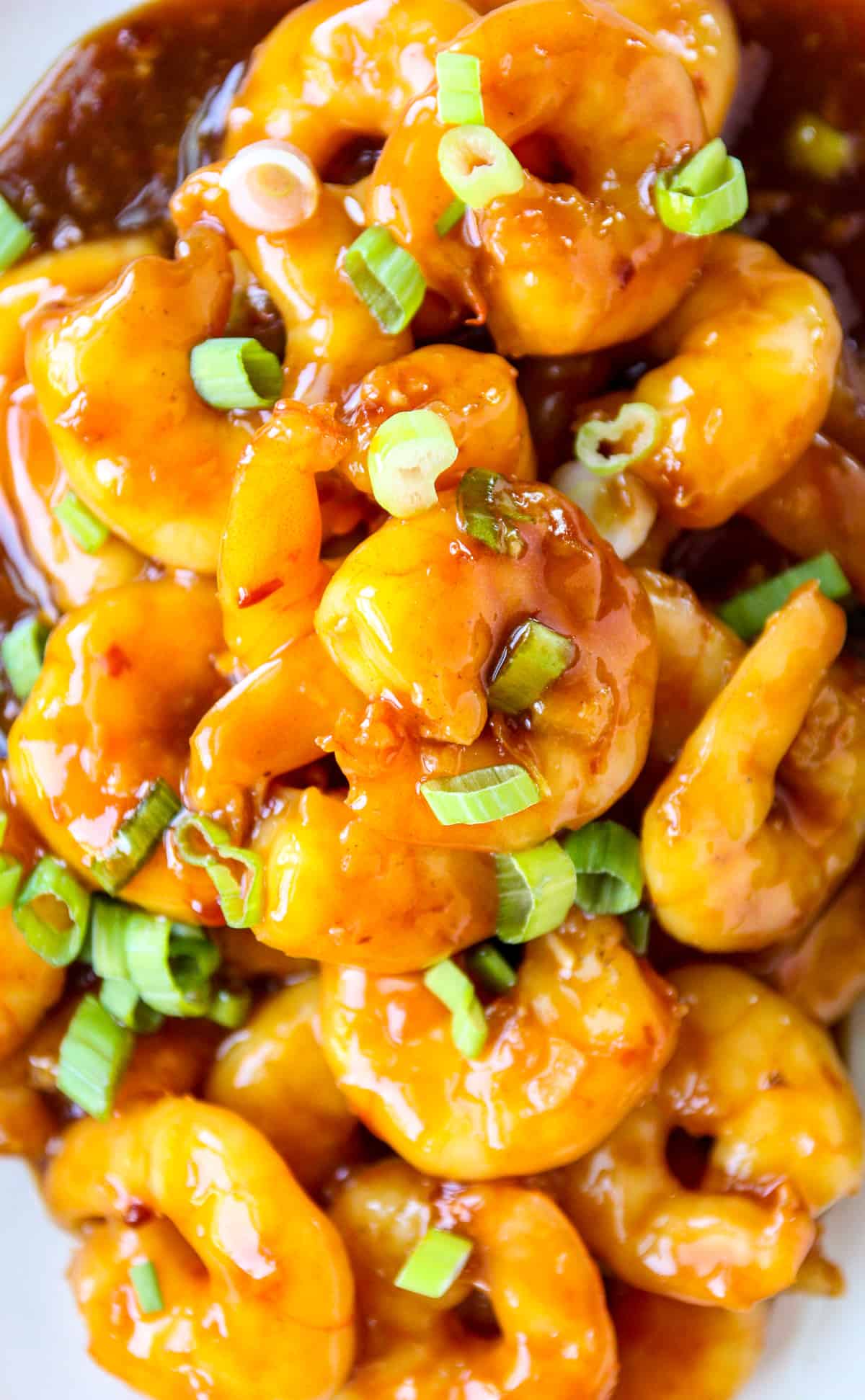General Tso shrimp garnished with green onion slices.
