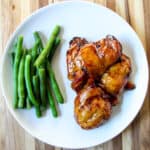 Air Fried Teriyaki Chicken on a white plate with green beans.