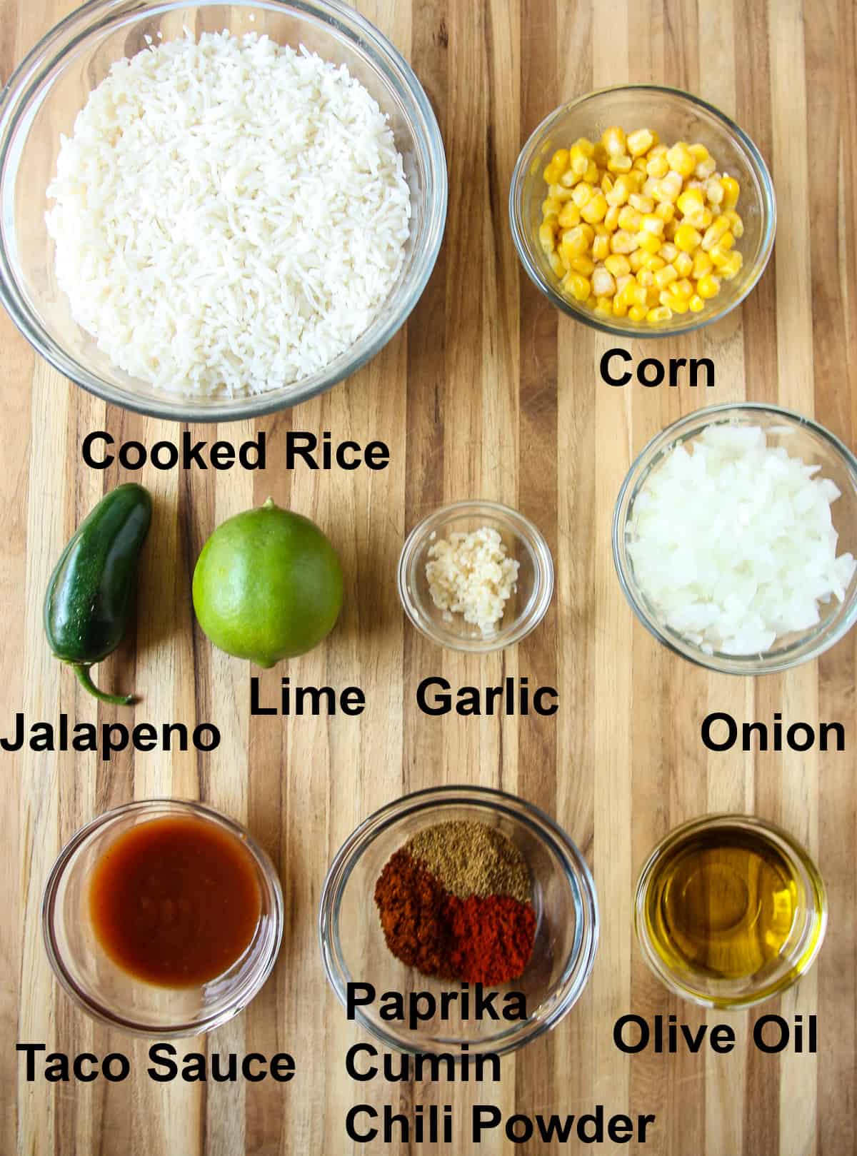 The ingredients for making this recipe in glass dishes on a wooden board.