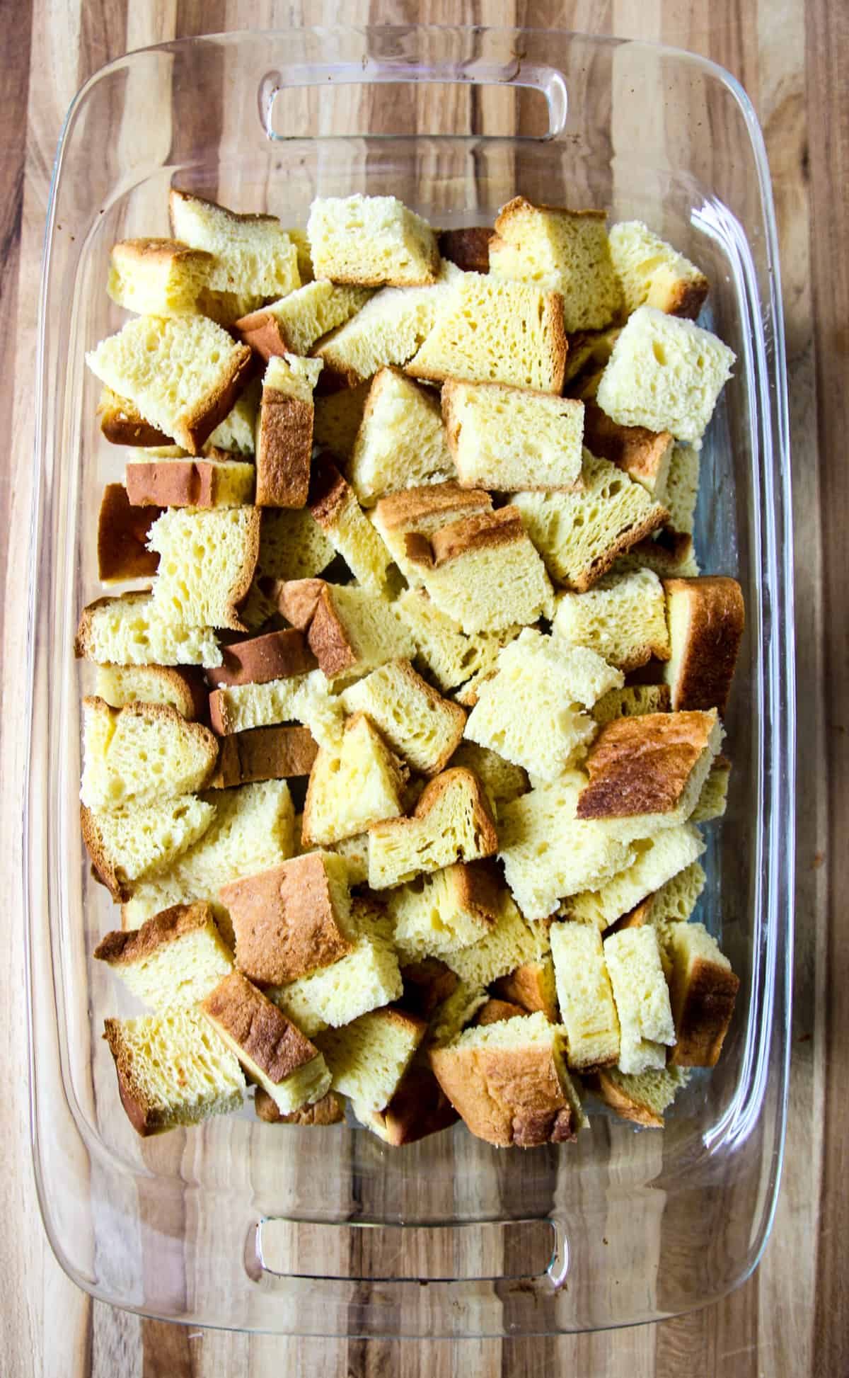 Cubes of bread in a glass baking dish.