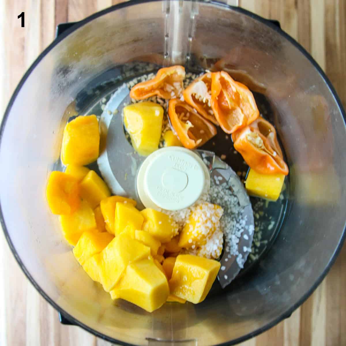 The ingredients in the bowl of a food processor.