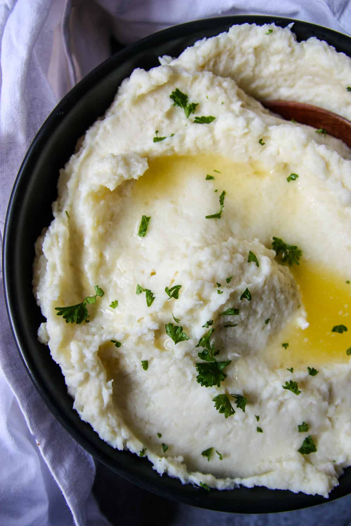 A close, top down shot of a dish of creamy parsnip puree.