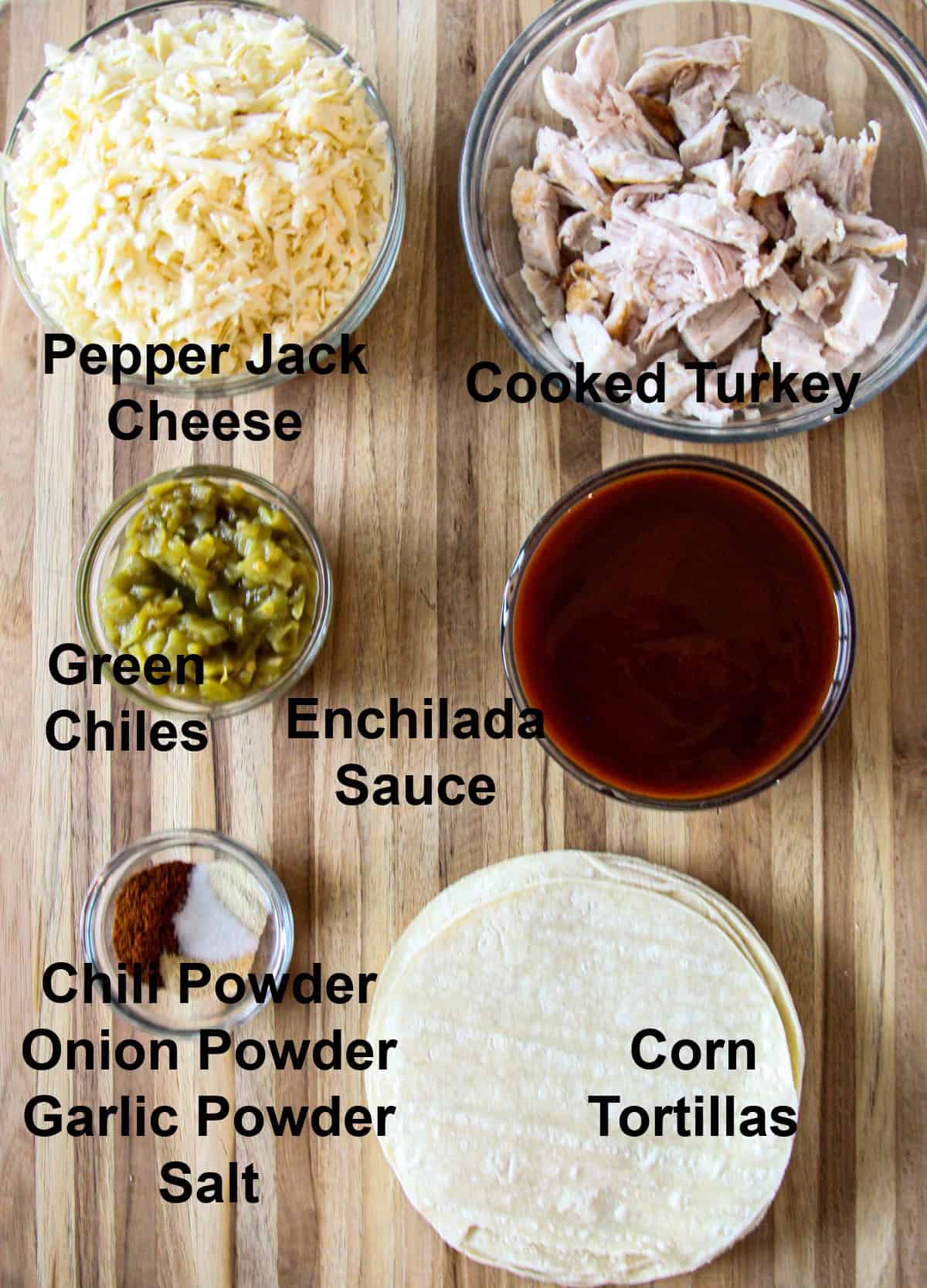 All of the ingredients for making this recipe in glass bowls on a wooden board.