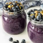 Blueberry chia pudding in two glass jars.